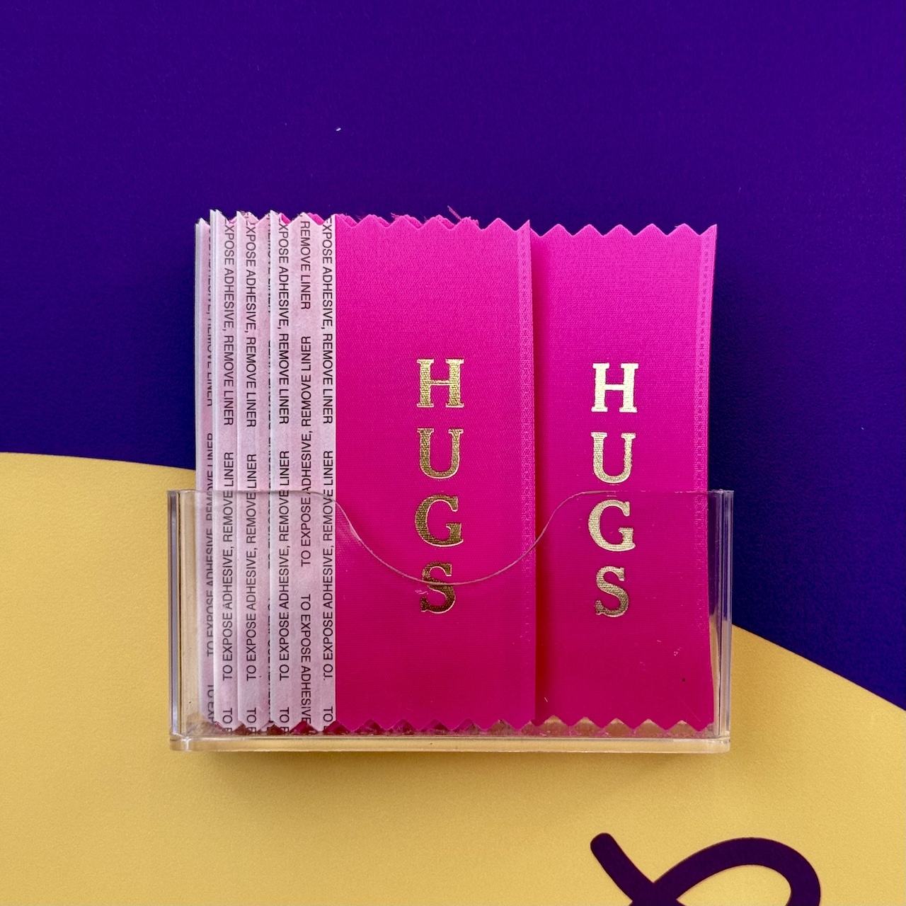 pink “hugs” ribbon