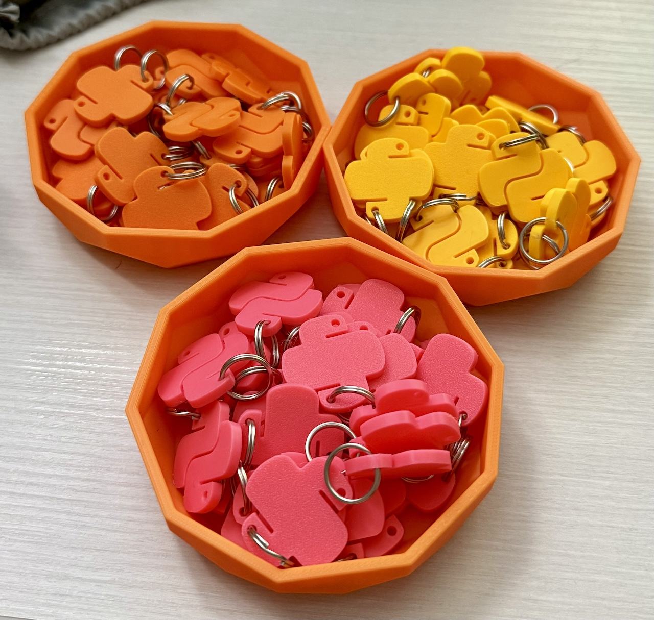 orange, yellow, and pink Python logo charms